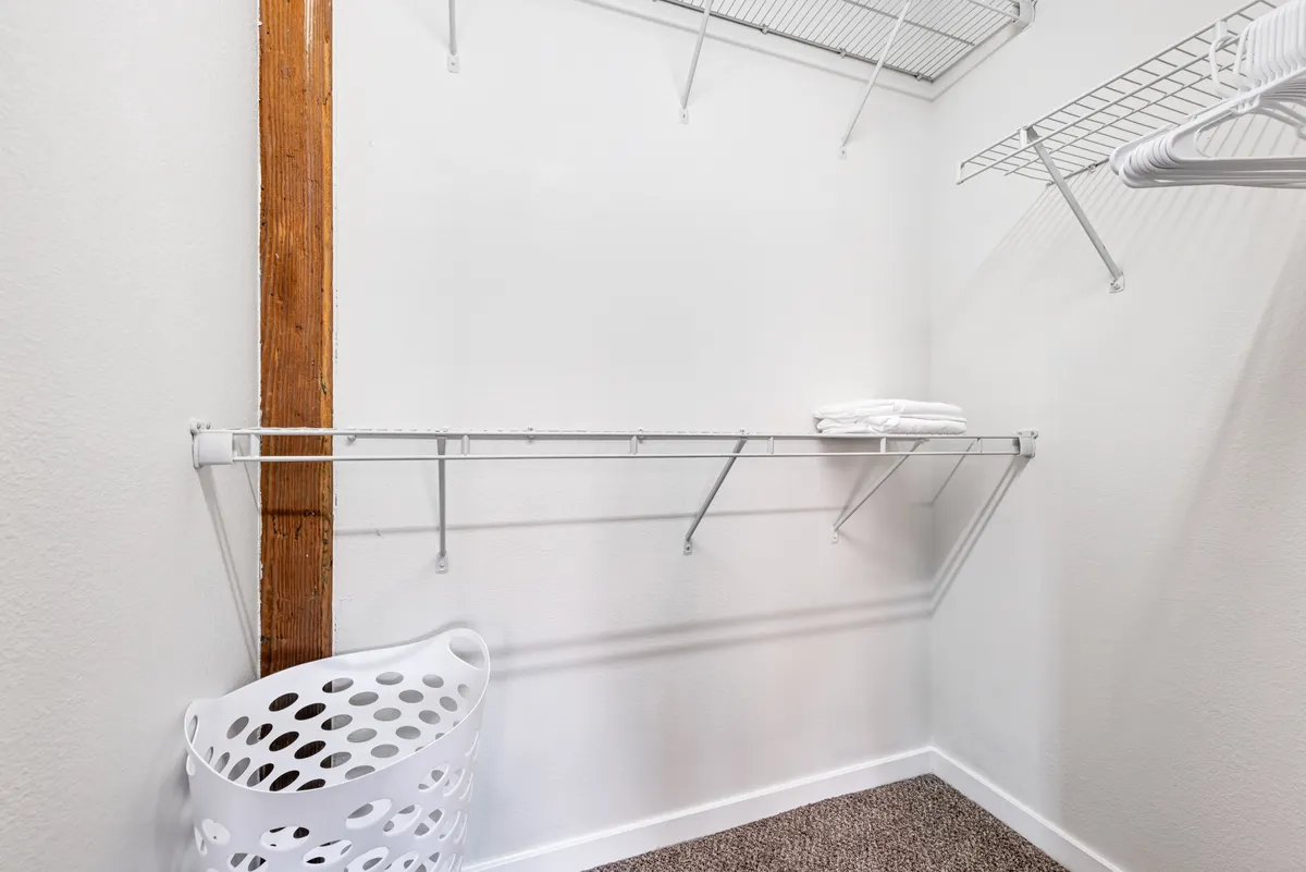 This image depicts a functional, organized interior shelving area complete with storage baskets and neatly folded towels. The space appears uncluttered and purposeful, evoking a sense of order and calm.